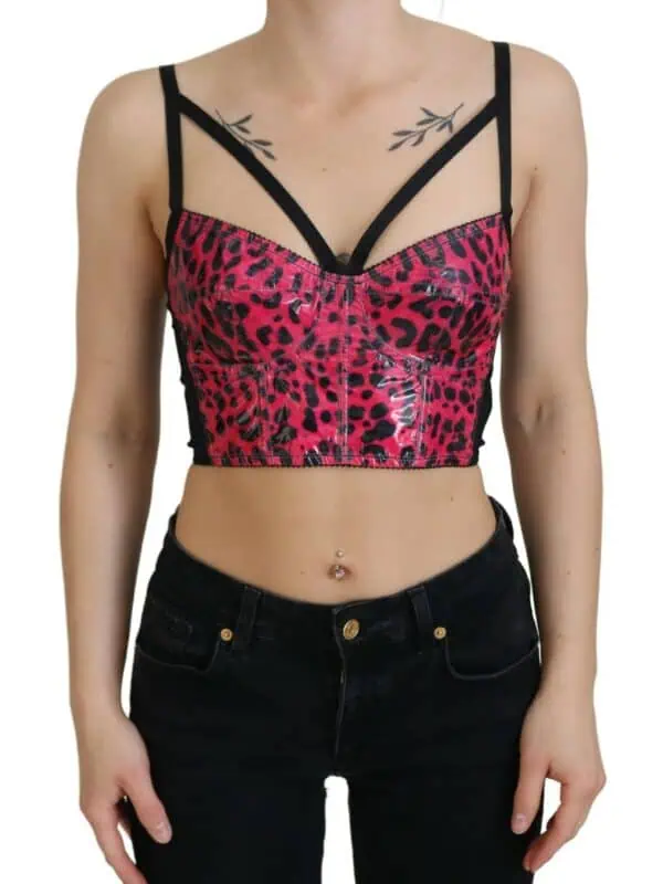 Leopard print bustier top with strappy black details and a glossy finish, styled with black jeans.