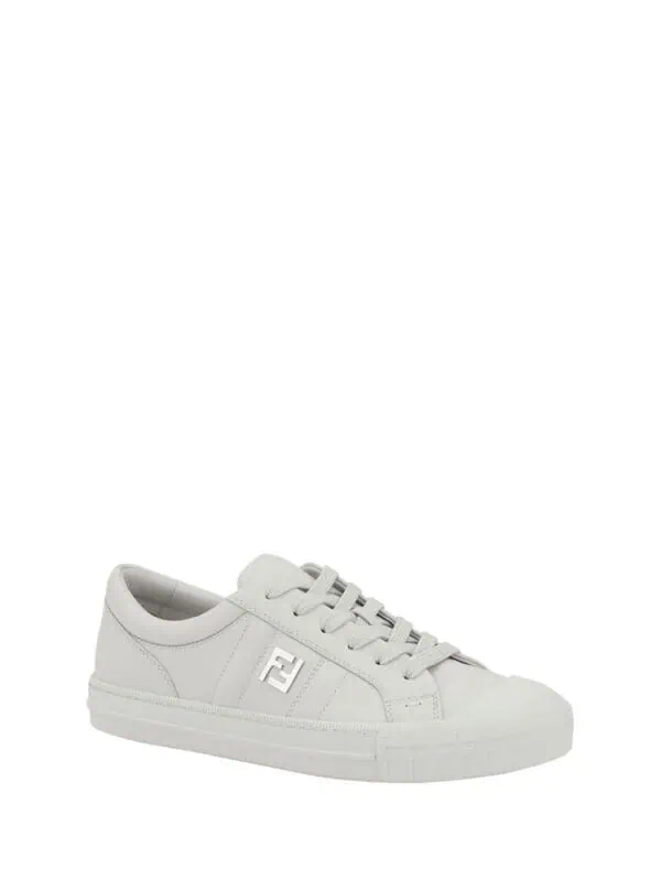 White luxury designer sneakers from Lux Brands, featuring a stylish logo detail, perfect for casual chic outfits.