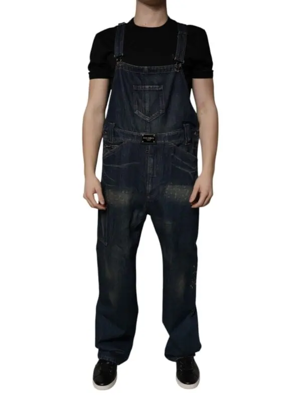 Relaxed-fit dark denim overalls with distressed detailing and multiple pockets, paired with a black t-shirt for a casual urban style. Perfect for streetwear or everyday casual looks.