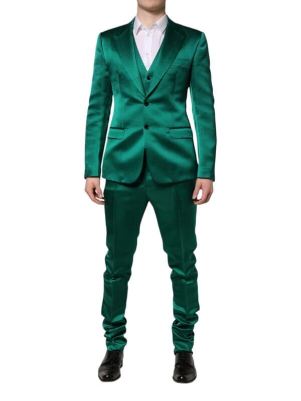 Shiny emerald green satin men's tuxedo suit with black shoes and white shirt for formal events, wedding, or prom. perfect for making a stylish statement and elegant appearance.