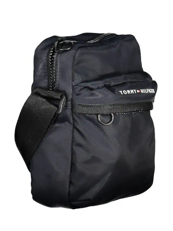 Black Tommy Hilfiger small shoulder bag with multiple zippered compartments.