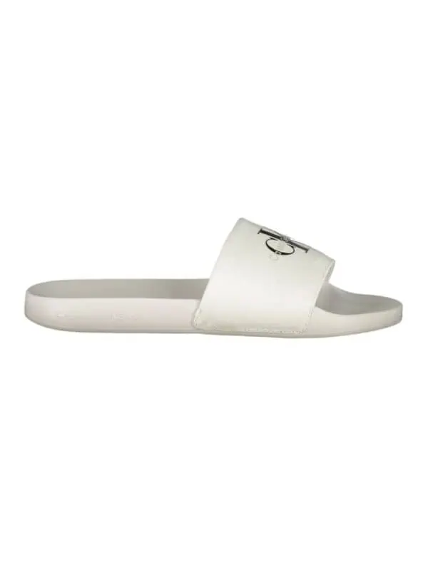 White Calvin Klein slide sandal with logo strap for casual luxury footwear.