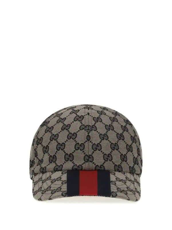 Gucci monogram canvas cap with red and blue stripe embellishment, luxurious fashion accessory.