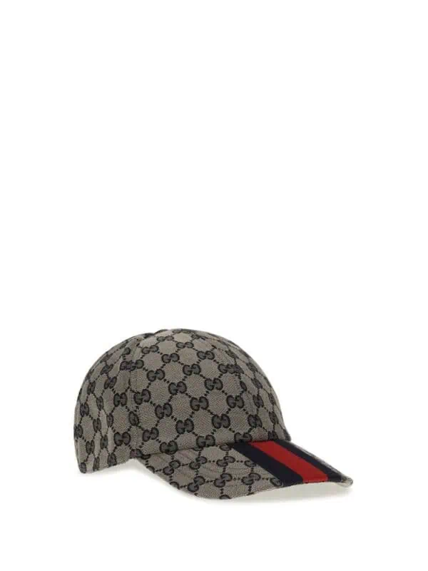 Gucci monogram baseball cap with red and black stripe detail, luxury designer accessory for stylish casual wear.
