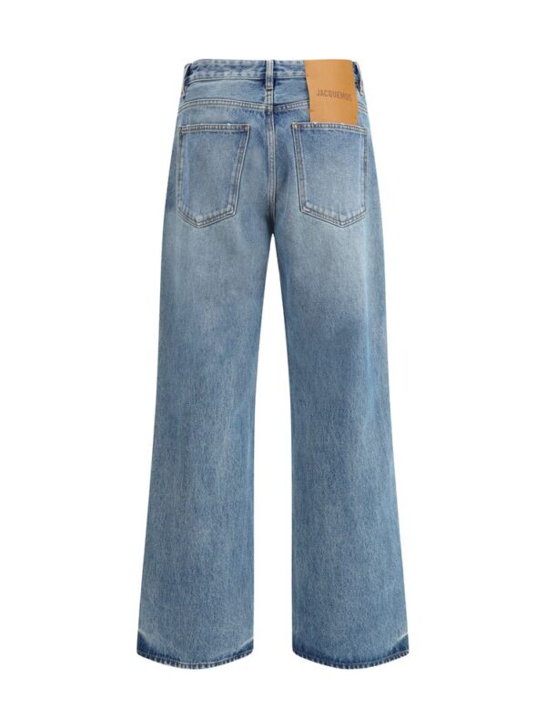 Mid-rise wide-leg blue denim jeans with back pockets and leather brand patch, casual and fashionable, perfect for stylish everyday wear.