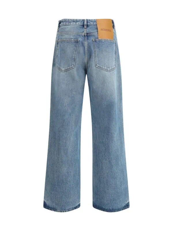Mid-rise wide-leg blue denim jeans with back pockets and leather brand patch, casual and fashionable, perfect for stylish everyday wear.
