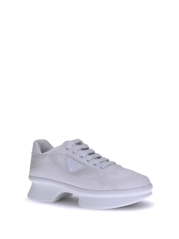 Luxury white chunky sneaker with mesh details and thick sole for a modern, stylish look.