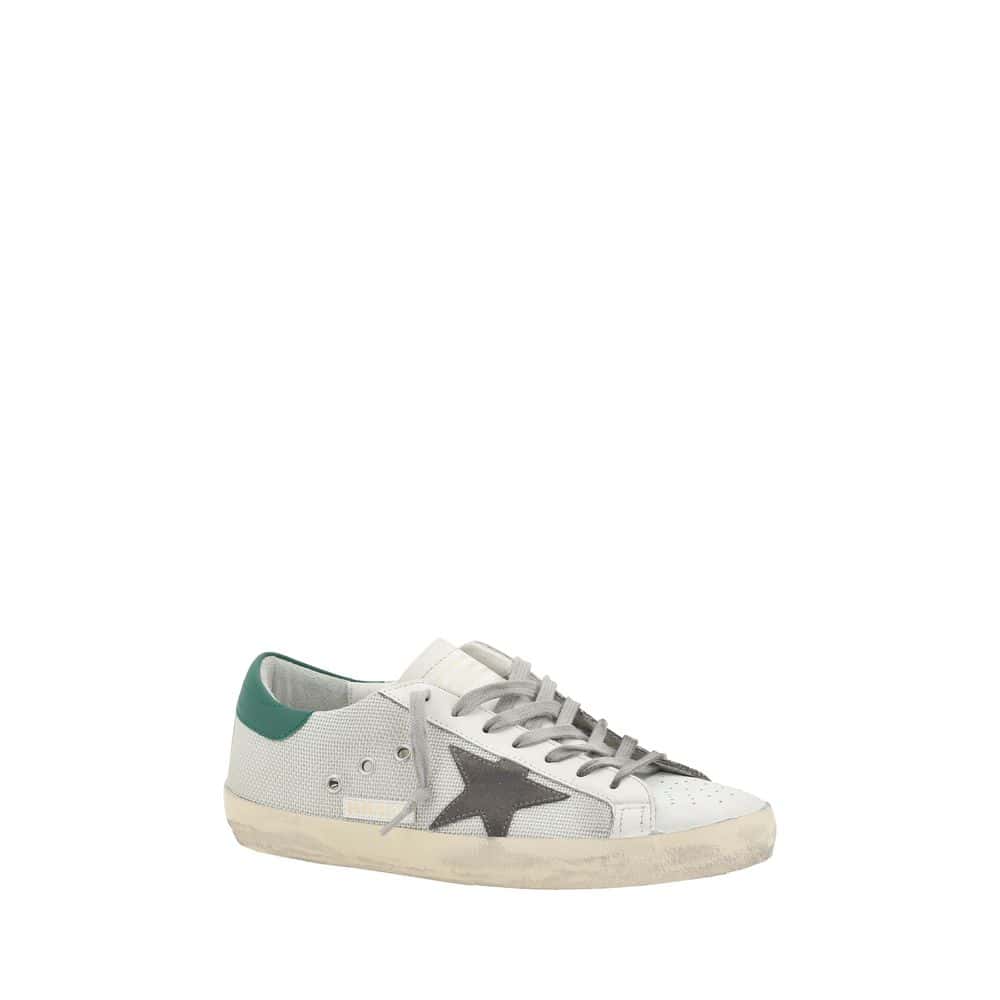 White low-top designer sneakers with black star detail and green heel accent, casual luxury footwear for men and women, Lux Brands style.