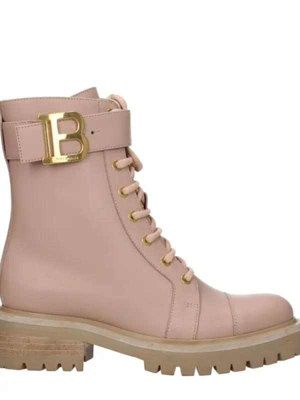 Pink leather designer combat boot with gold Balmain logo buckle and chunky sole.
