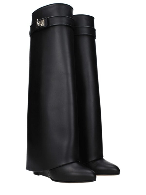 Elegant black knee-high boots with a sleek design and silver buckle detail, perfect for stylish and sophisticated winter or fall fashion.