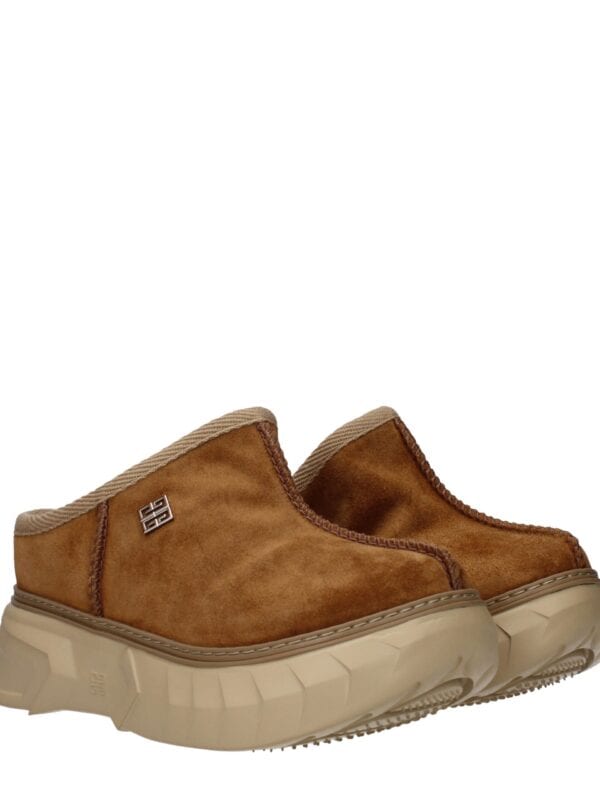 Comfortable brown suede slip-on sneakers with chunky beige sole and stylish small metal logo detail, perfect for casual and everyday wear.