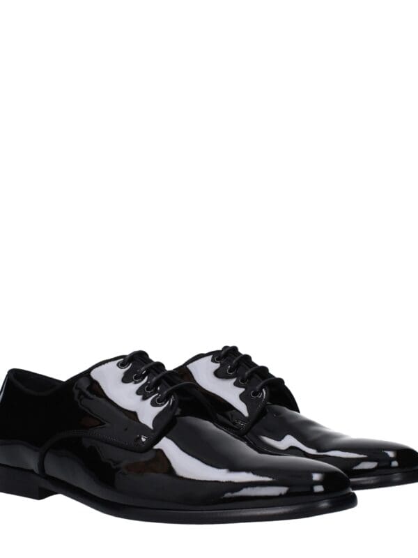 Stylish black patent leather dress shoes with sleek design, lace-up closure, and glossy finish, perfect for formal occasions and adding a touch of luxury to any outfit.