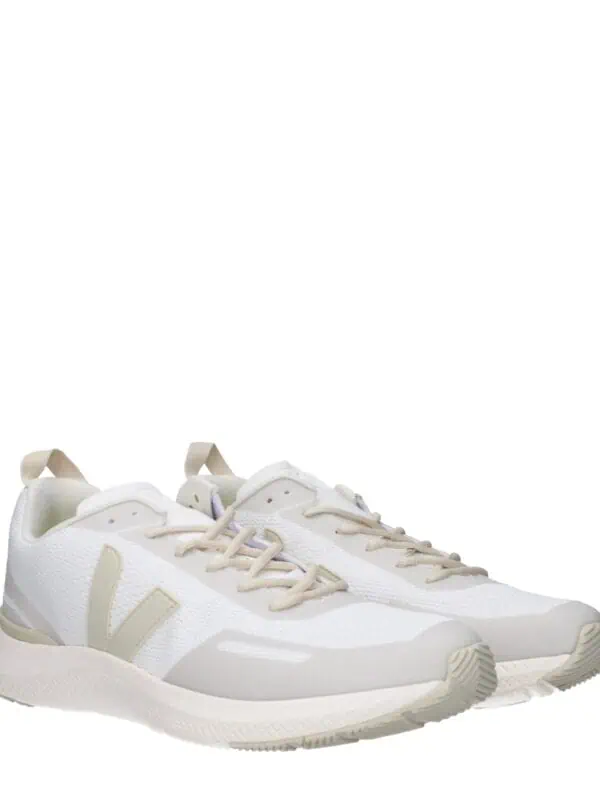 Comfortable white athletic sneakers with beige accents, breathable mesh uppers, and cushioned soles perfect for casual wear and workouts.