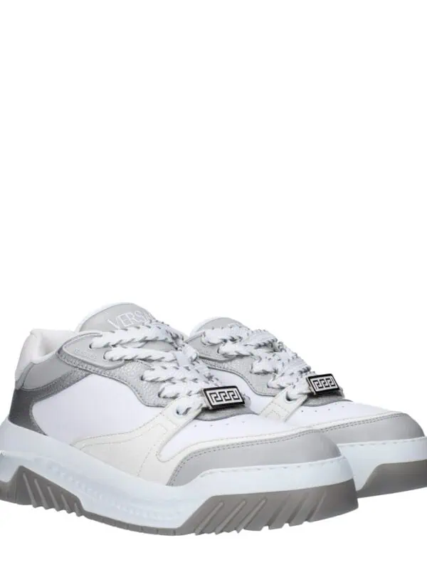 Stylish white and grey Versace sneakers with chunky sole, intricate detailing, and logo accents for a luxurious, on-trend look. Perfect for fashion-forward casual wear.