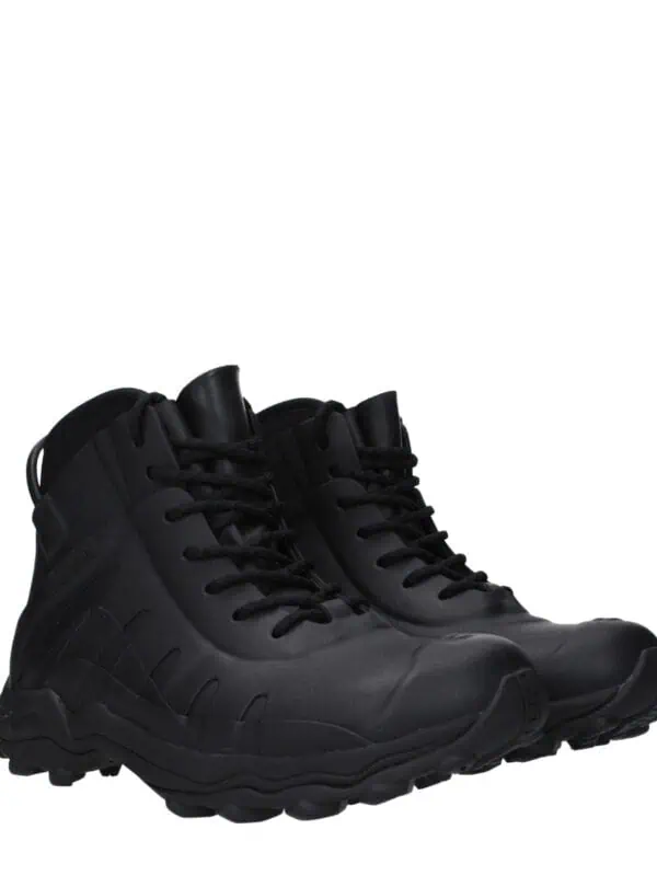 Black tactical waterproof hiking boots with rugged soles, designed for durability and outdoor adventures. Perfect for hiking, trekking, and outdoor work in challenging terrains.