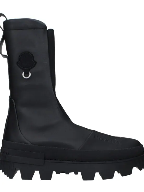 Black Moncler high-top waterproof boots with rugged sole and logo detail for luxury outdoor footwear.