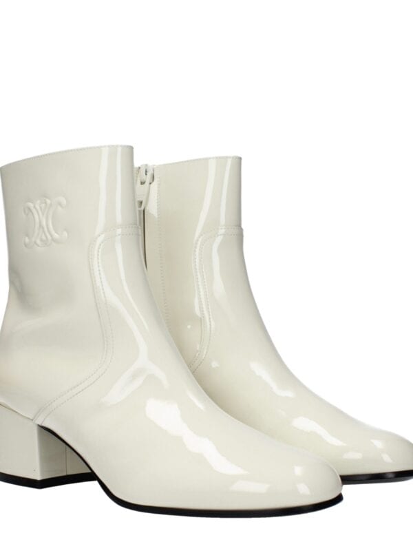 Elegant white patent leather ankle boots with a block heel, side zipper for easy wear, and embossed logo detail, perfect for chic fashion statements.