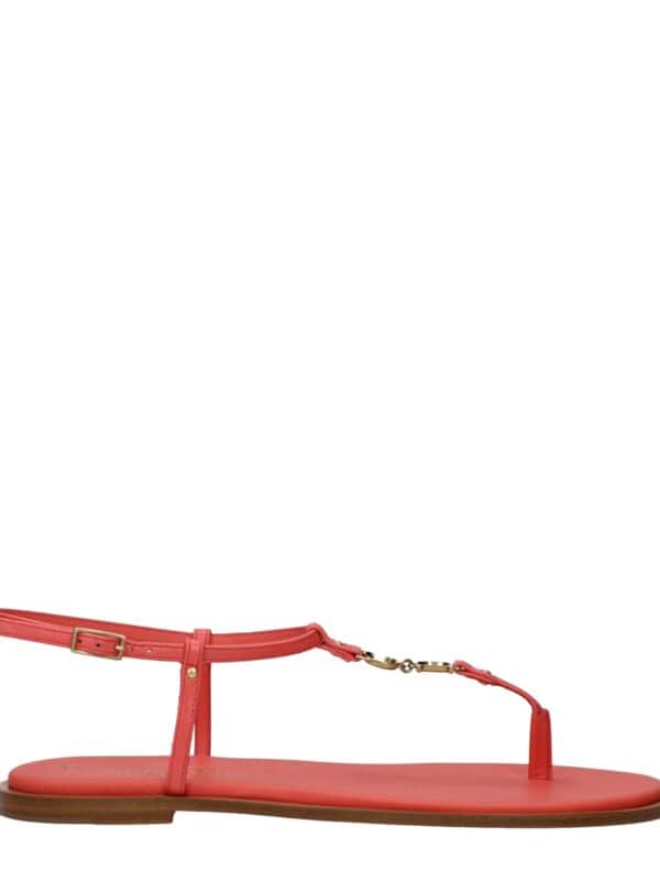 1. Coral pink flat T-strap sandal with adjustable ankle strap, gold hardware, and wooden sole for a stylish summer look.