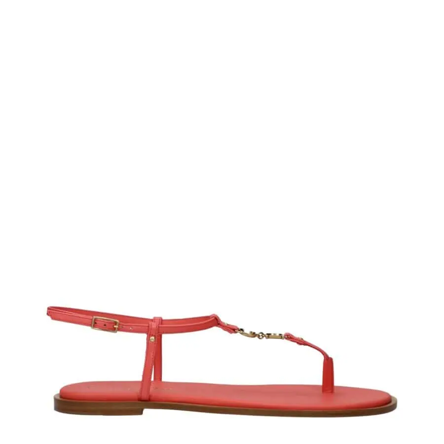 1. Coral pink flat T-strap sandal with adjustable ankle strap, gold hardware, and wooden sole for a stylish summer look.