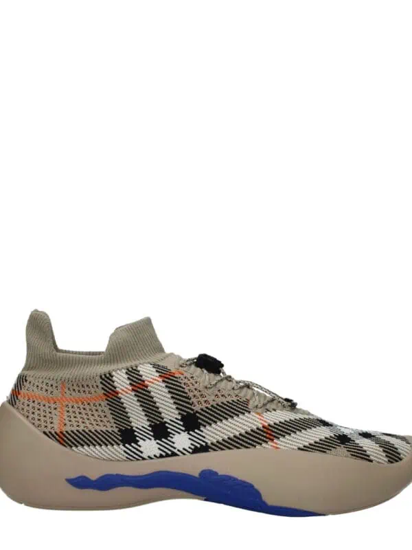 1. Stylish designer sneaker featuring a plaid pattern, sock-like ankle collar, and cushioned sole with blue accents for modern comfort and fashion.