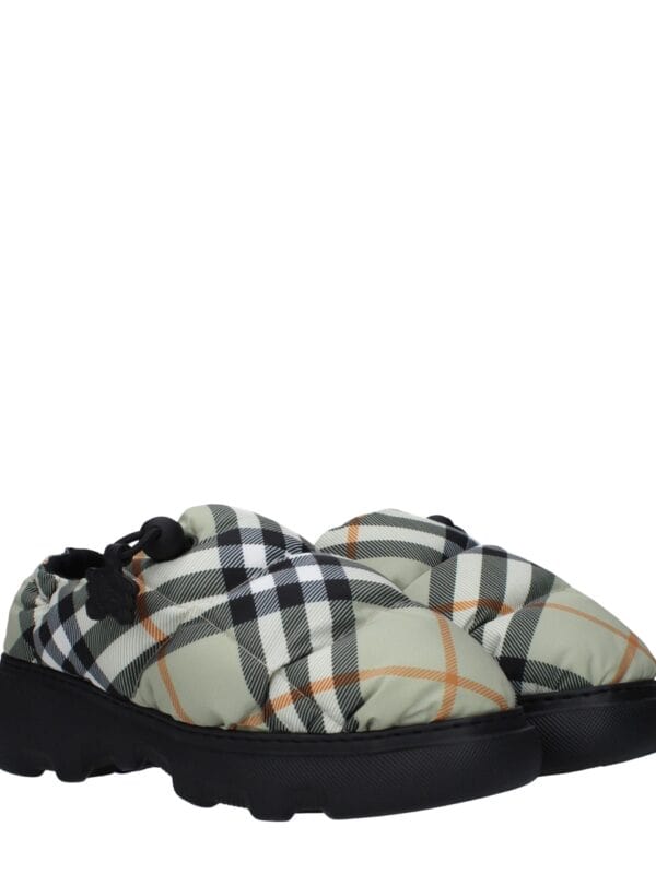 Comfortable designer quilted slip-on shoes with a black and white checkered pattern and cushioned sole, perfect for casual luxury style.
