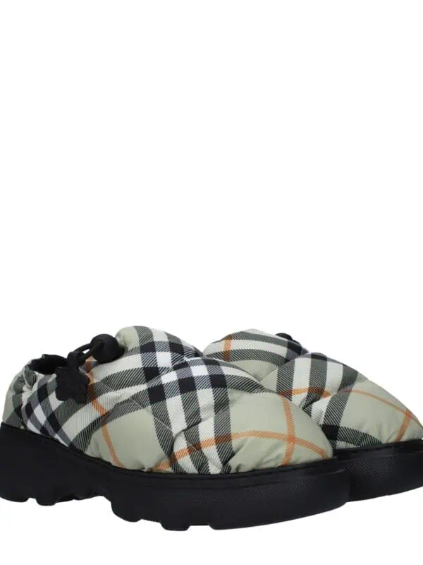 Comfortable designer quilted slip-on shoes with a black and white checkered pattern and cushioned sole, perfect for casual luxury style.
