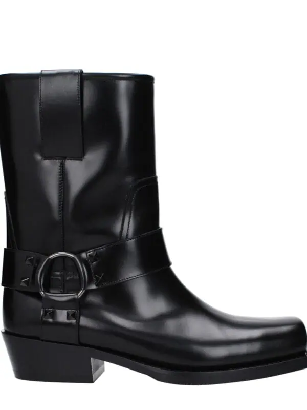 Black leather knee-high fashion boot with silver buckle detail and block heel, stylish and versatile for trendy everyday wear or special occasions.