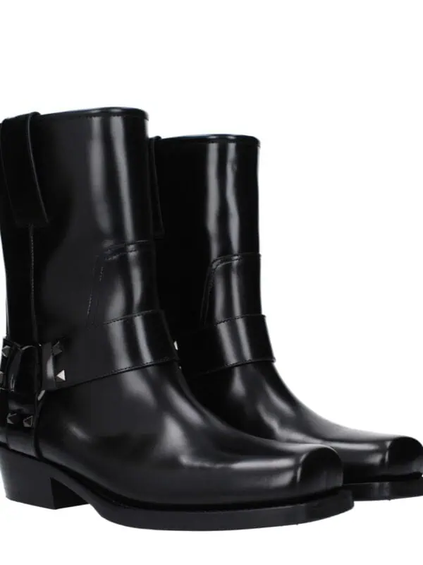 Luxurious black leather ankle boots with buckle embellishments, sleek design, and low heel, perfect for stylish and versatile footwear.