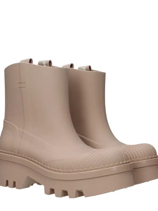 Rubber beige waterproof ankle boots with chunky soles and pull tabs, designed for rain protection and fashionable urban style. Perfect for wet weather and outdoor activities.