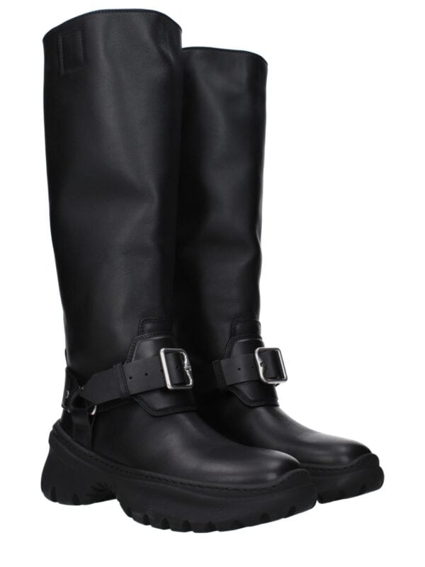 Elegant black designer knee-high boots with adjustable straps and rugged sole for luxury fashion statement. Perfect for stylish, high-end streetwear or sophisticated casual looks.