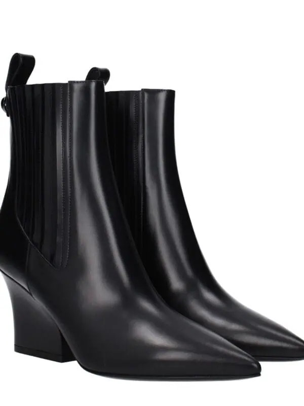Elegant black leather pointed-toe ankle boots with a sleek design, high block heel, and zipper detail, perfect for stylish and sophisticated outfits.