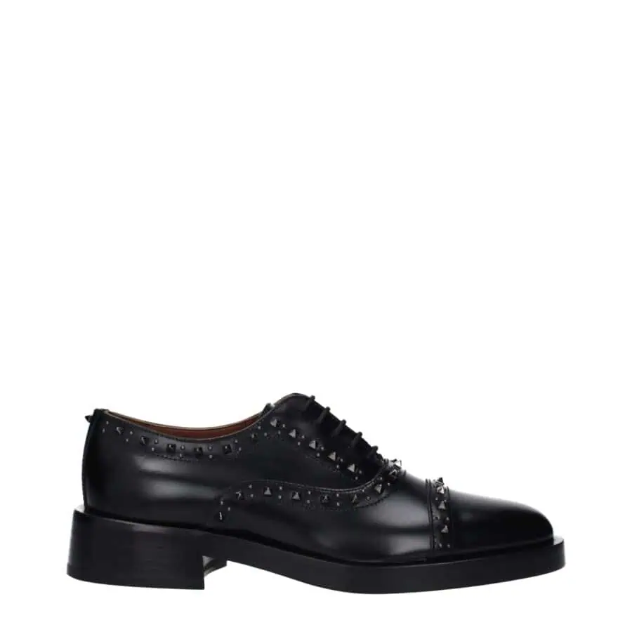 Bold black leather oxford shoe with silver stud embellishments, stylish laces, and a sturdy heel, perfect for sophisticated fashion statements and formal occasions.