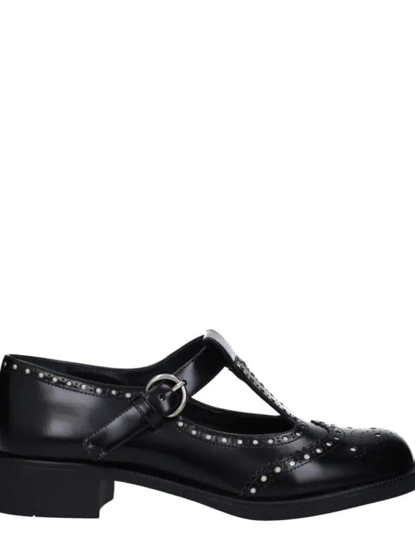 High-quality black leather Mary Jane shoes with brogue detailing, buckle strap, and sturdy low heel, perfect for stylish and comfortable everyday wear.