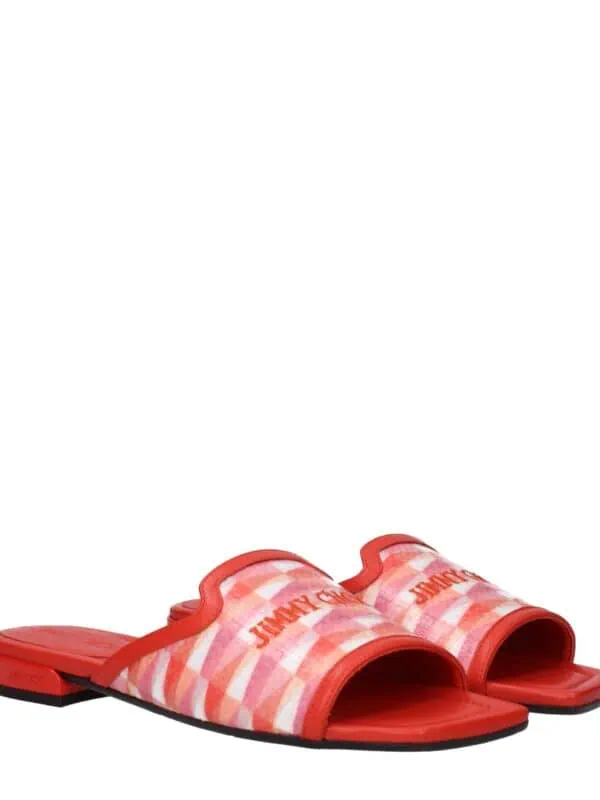 Red patterned slip-on designer sandals with "JIMMY CHOO" branding, cushioned footbed, and open toe featuring a chic, casual style perfect for summer outings.
