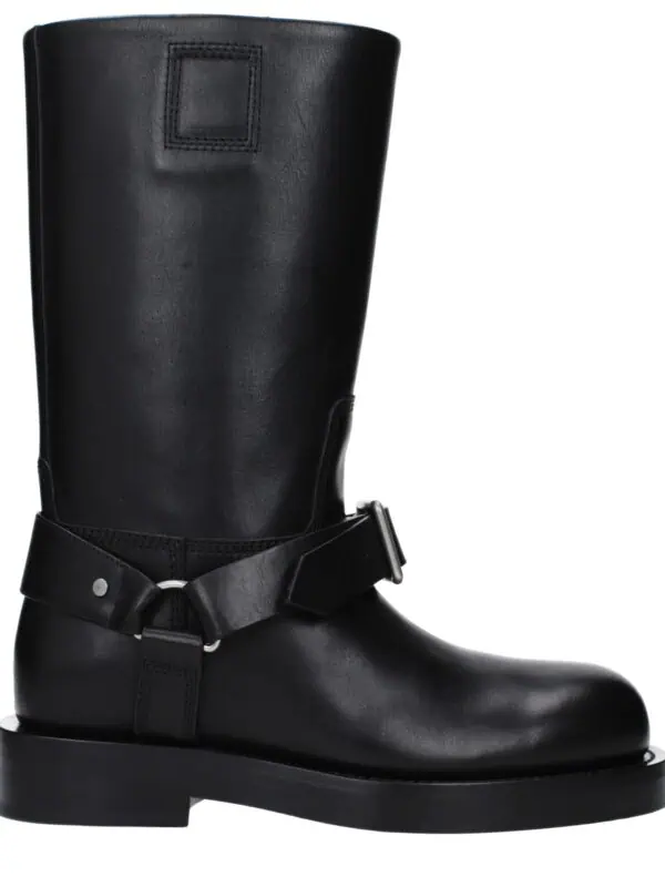 1. Black leather knee-high fashion boot with adjustable strap and buckle detail, perfect for luxury and stylish winter wear.