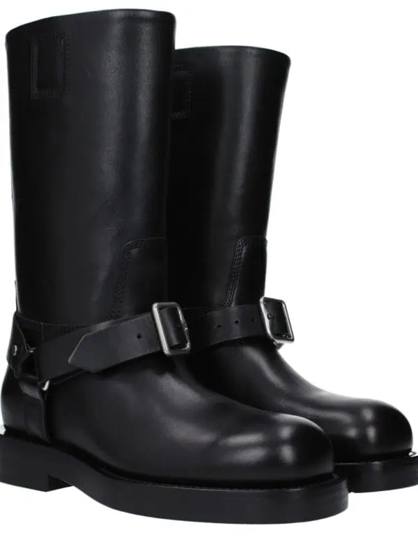 Lux black leather knee-high boots with buckle strap detail, stylish and versatile footwear for high fashion and everyday wear. Perfect for adding a luxurious touch to your wardrobe.