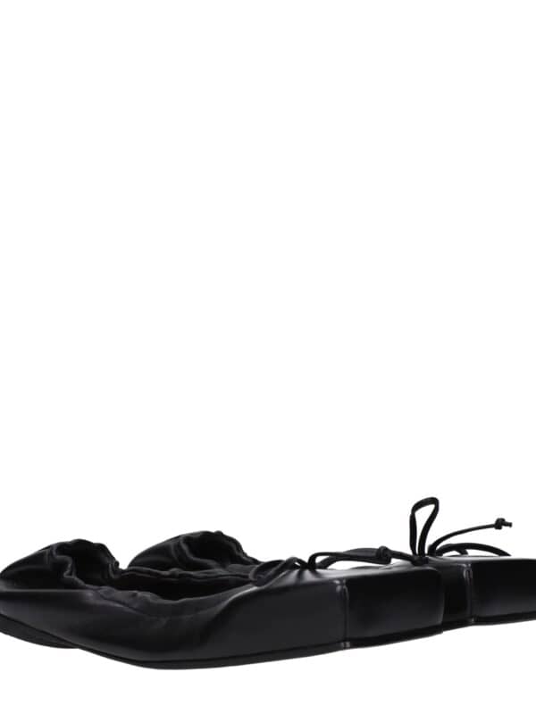 Luxury black leather ballet flats with elasticized ruffle detailing and adjustable lace ties for a stylish and comfortable fit. Perfect for everyday wear and elegant casual looks.
