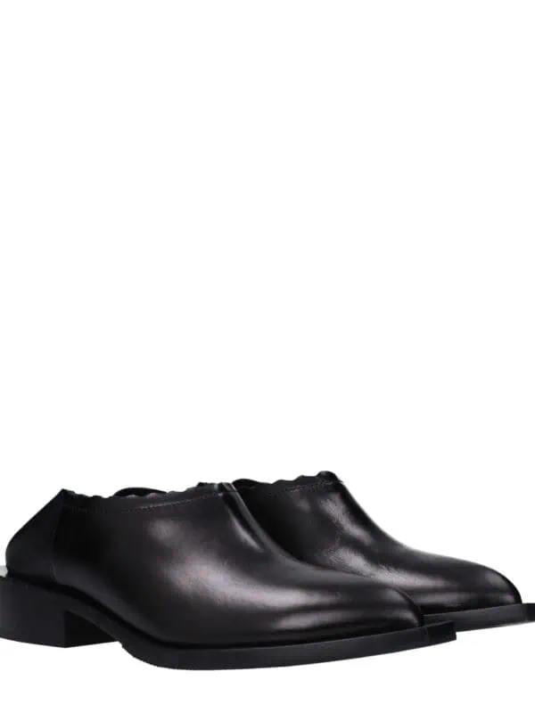 Elegant black leather men's shoes with a sleek design, perfect for formal occasions and stylish everyday wear, featuring a comfortable low heel and smooth finish.