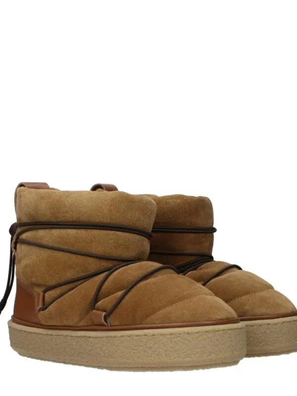 Soft tan suede and leather ankle boots with thick rubber soles, padded collar, and stylish lace-up design for a luxurious casual look.