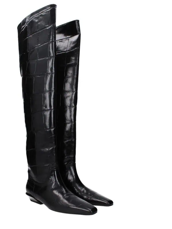 Black crocodile leather knee-high boots with pointed toes and low heels for luxury fashion.