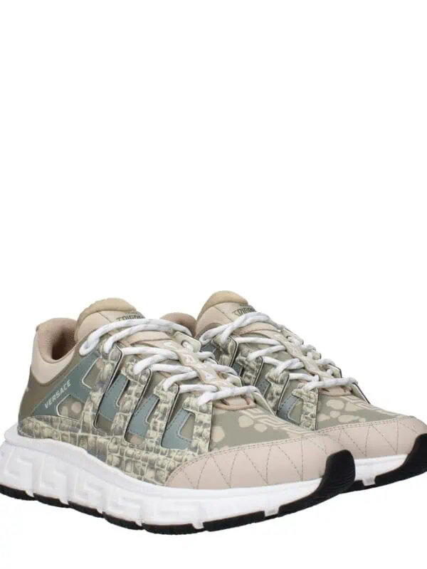 Luxury beige and light blue Versace sneakers with crocodile-embossed accents and bold logo details, perfect for adding sophistication to casual or sporty outfits.