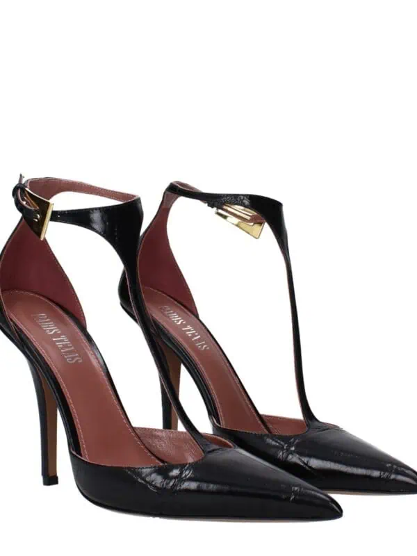 Elegant black patent leather stilettos with pointed toes and ankle straps featuring gold buckle accents, perfect for upscale fashion and special occasions.