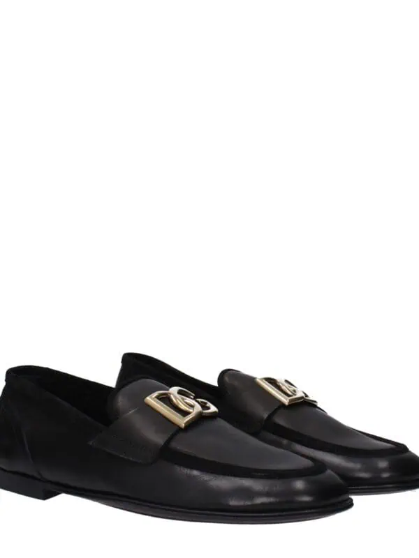 Luxury black leather loafers with gold-tone hardware and classic slip-on design, perfect for sophisticated style and all-day comfort.