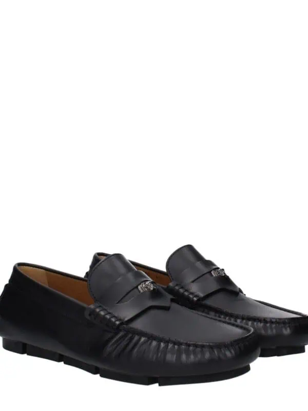 Luxury black leather loafers with decorative silver accents, slip-on design, and textured rubber soles, perfect for stylish casual or semi-formal wear.
