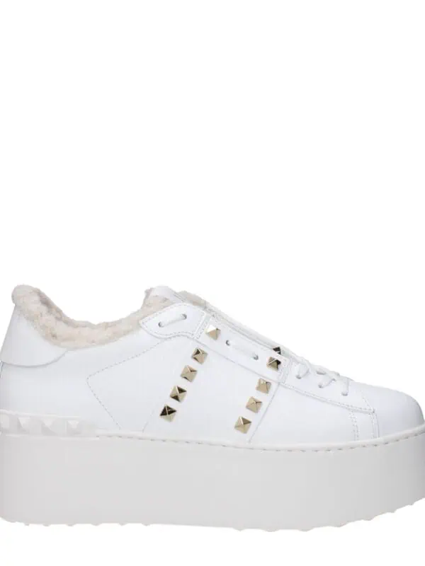 Luxurious white platform sneaker with gold stud accents, faux fur lining, and chunky sole, perfect for stylish comfort and trendy streetwear outfits.