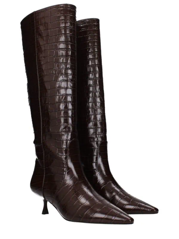Dark brown crocodile-embossed leather knee-high boots with pointed toes and stiletto heels, perfect for a luxurious and stylish look.