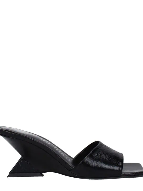 Lux Brands black leather open-toe slip-on mule with unique geometric heel for a modern, chic look. Perfect for stylish casual or evening wear, combining comfort and fashion effortlessly.