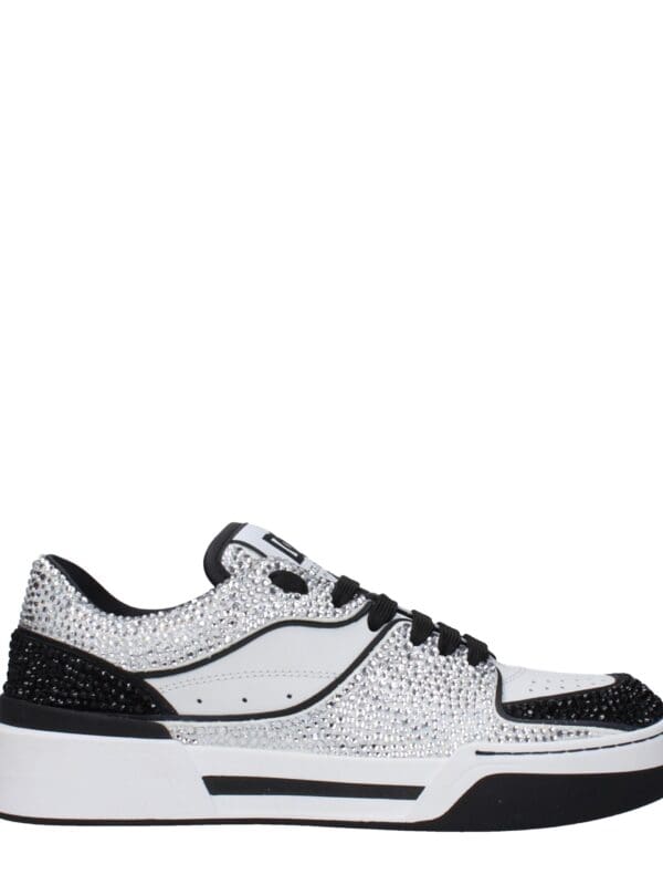 Sparkly white and black rhinestone-encrusted designer sneakers with a chunky sole, perfect for luxury streetwear style and upscale casual wear.