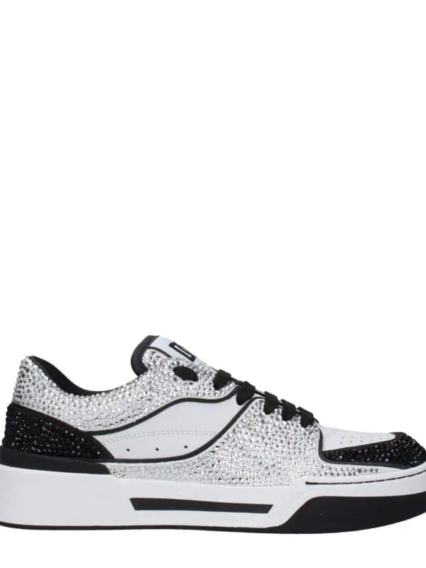 Sparkly white and black rhinestone-encrusted designer sneakers with a chunky sole, perfect for luxury streetwear style and upscale casual wear.
