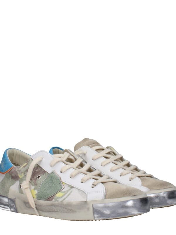 1. Unique designer sneakers with a floral pattern, white accents, and distressed soles for a stylish, modern look.